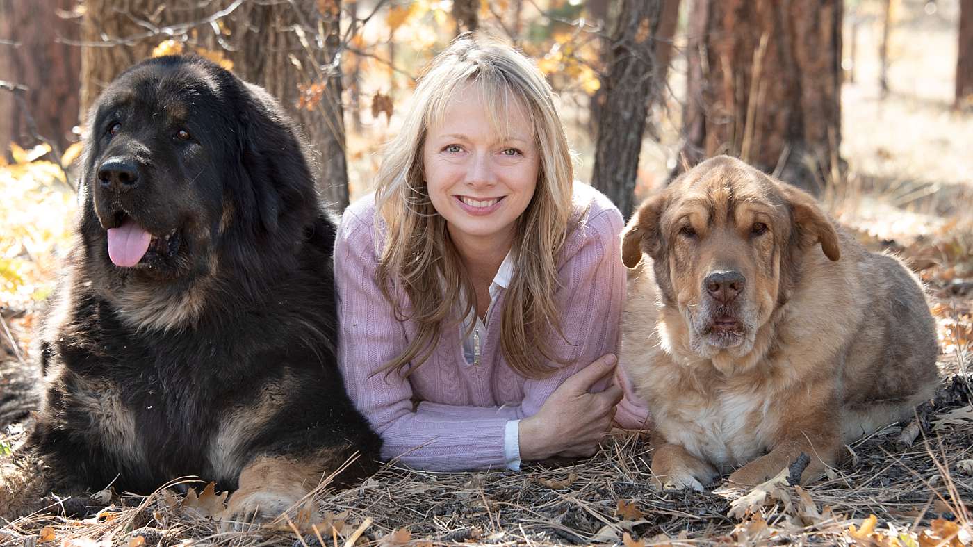 Flagstaff Pet and Headshot Photographer with her dogs a Tibetan Mastiff and Reservation Dog in the forest during the fall with fall colors under an oak tree